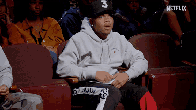 a man in a hoodie with the number 3 on it