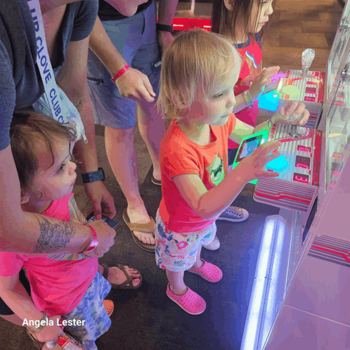 a little girl playing a game with angela lester written on the bottom