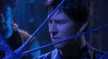 a man is surrounded by blue wires and says " i forgot all about that rule " .