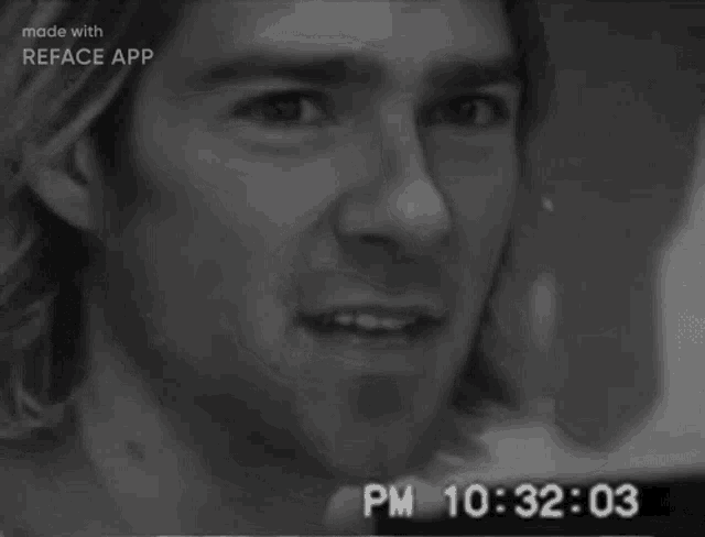 a black and white photo of a man with the time 10:32 on the bottom