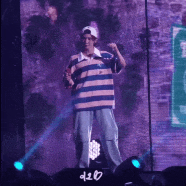 a man wearing a striped shirt and a hat stands on a stage with a sign that says d20
