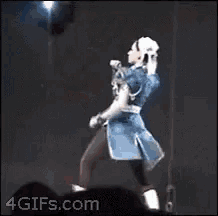 a woman in a video game character costume is kicking up her leg