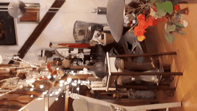 a room with a lot of decorations including a vase with flowers on it