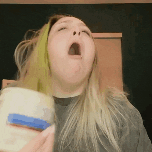 a woman with her mouth open is holding a jar of petroleum jelly