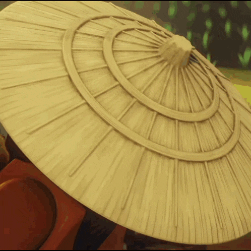 a straw hat with a circular design on it