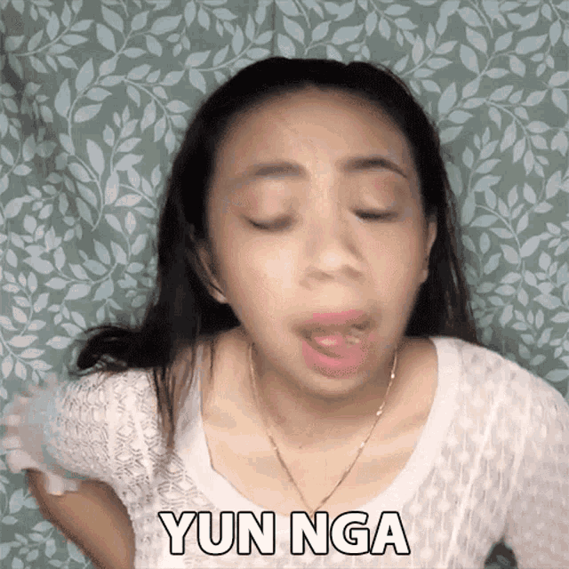 a woman is making a funny face with yun nga written on her chest