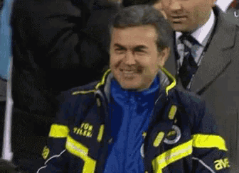 a man wearing a blue and yellow jacket that says fox tilan