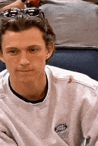 a close up of a man wearing sunglasses and a white sweatshirt .
