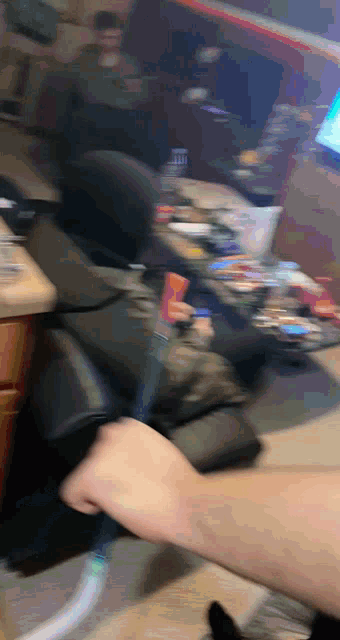 a blurry photo of a person holding a remote control