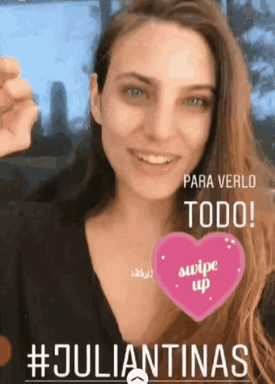 a woman is smiling with a heart that says swipe up on it