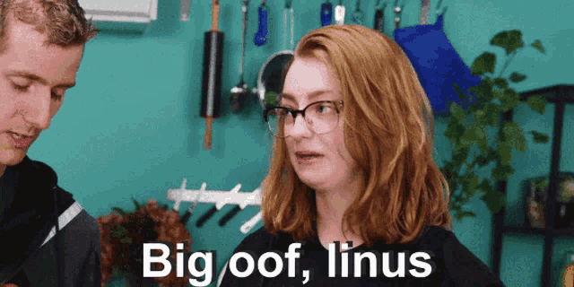 a woman with red hair and glasses says big oof linus