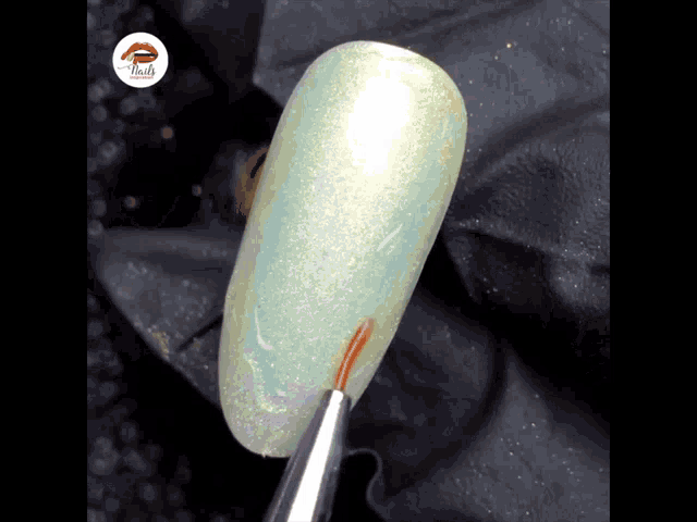 a close up of a nail with the word nails on the bottom left