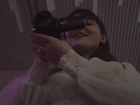 a woman holding a sony 4k camera in her hands