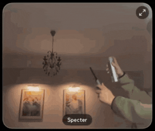 a person taking a picture of a ceiling light with a specter button