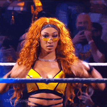 a female wrestler wearing sunglasses and a headband with a greek key design