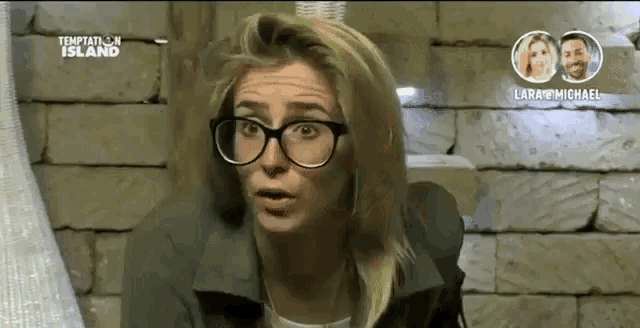 a woman wearing glasses and a green jacket is on temptation island