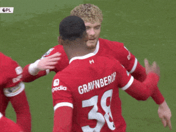 a soccer player wearing a red jersey with the number 38 on it