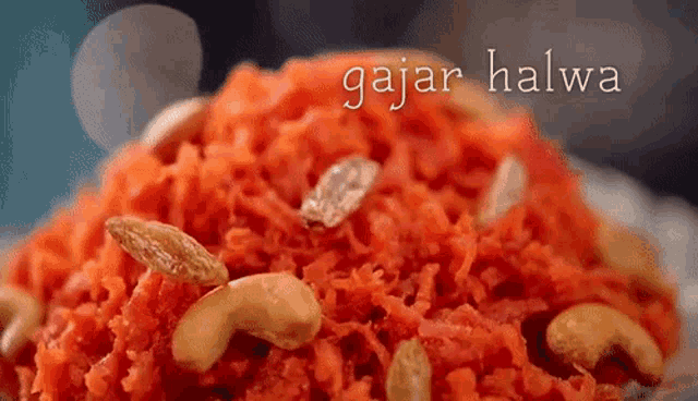 a close up of a plate of carrot halwa with cashews