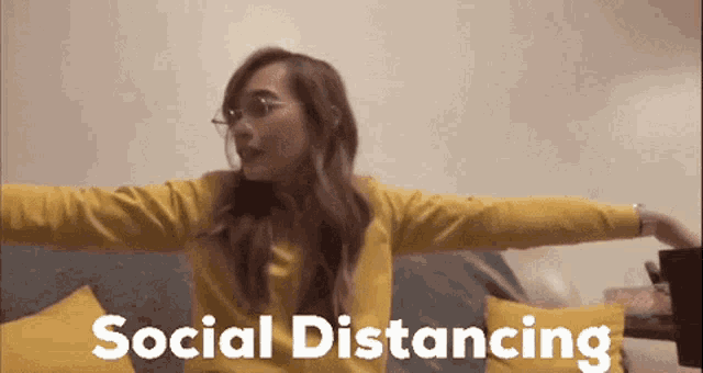 a woman is sitting on a couch with her arms outstretched and the words social distancing written above her