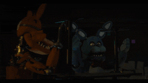 a person is holding a blue object in their hand in a dark room