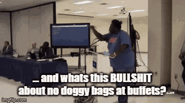 a woman stands at a podium in front of a screen and says and whats this bullshit