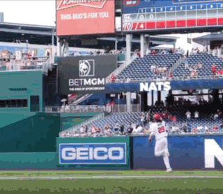a baseball player with the number 25 on his jersey is running towards the base