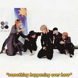 a group of people kneeling on the floor with the words something happening over here