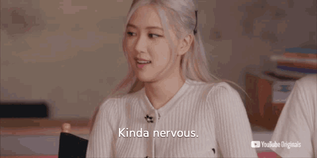 a woman sitting in a chair with the words kinda nervous on the bottom