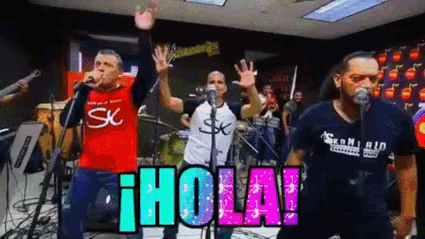 a group of men singing in front of microphones with the word hola written on the bottom