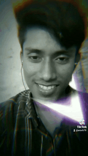 a black and white photo of a young man with a tiktok watermark
