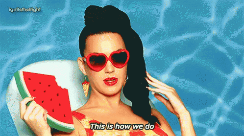 a woman wearing heart shaped sunglasses is holding a slice of watermelon and saying this is how we do