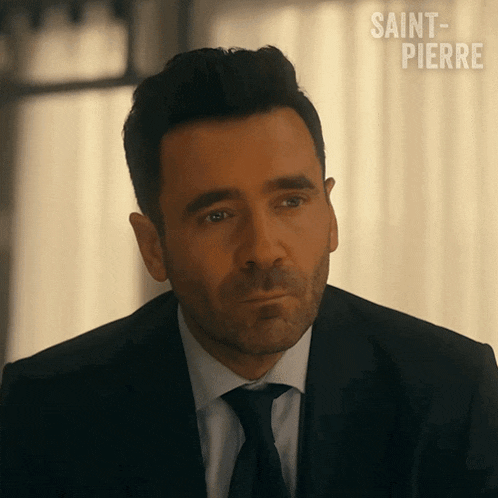 a man in a suit and tie with saint pierre written on the bottom right