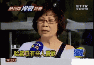 a woman wearing glasses is talking into a microphone on a tv channel