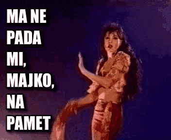 a woman is dancing in front of a sign that says ma ne pada mi majko na pamet .