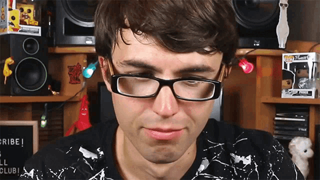 a man wearing glasses and a funko pop fisherman
