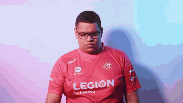 a man wearing a red shirt that says legion on it