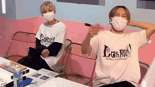 a man wearing a white t-shirt that says cosmo