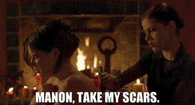 two women are sitting in front of a fireplace with the words manon take my scars