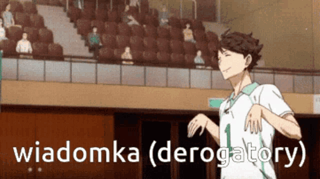 a man in a white shirt is running in a stadium with the words wiadomka ( derogatory ) written on the bottom