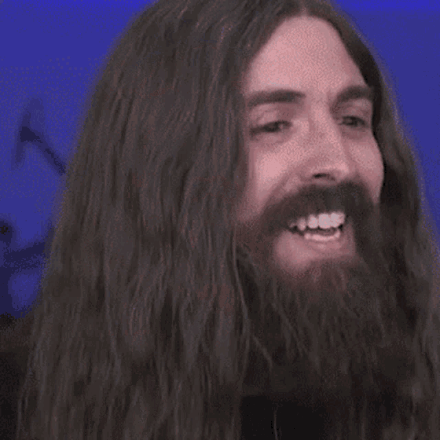a man with a beard is making a surprised face
