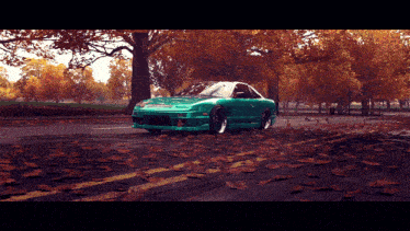 a green car is driving down a road surrounded by trees