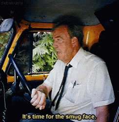 a man in a white shirt and tie is driving a yellow car and says it 's time for the smug face