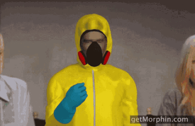 a man in a yellow suit with a gas mask and blue gloves stands in front of a getmorphin.com logo