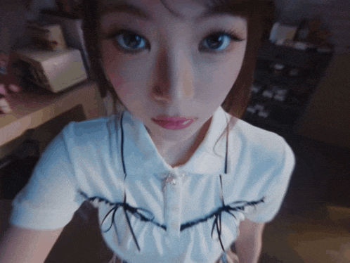 a close up of a woman taking a selfie with her eyes closed