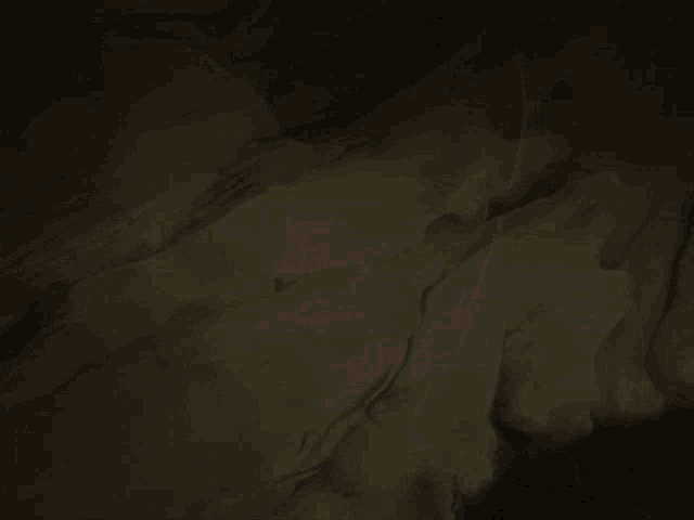 a girl with white hair and purple eyes is standing in a dark room