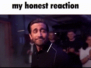 a man is smiling in front of a crowd with the words `` my honest reaction '' .