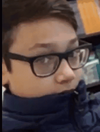 a close up of a person wearing glasses and a scarf