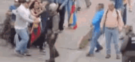 a blurry picture of a group of people walking down a street