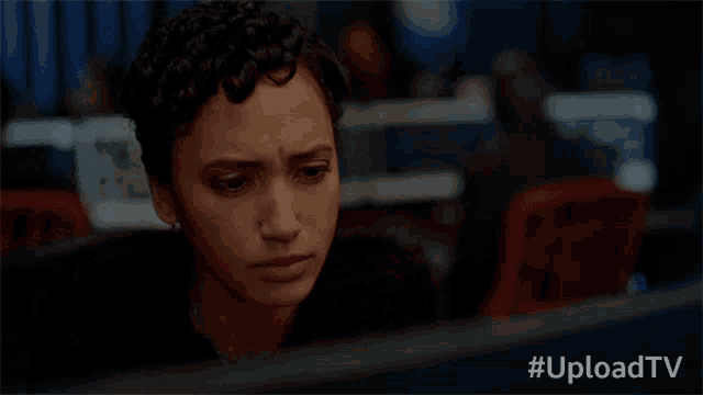 a woman is looking at a computer screen with the hashtag #uploadtv