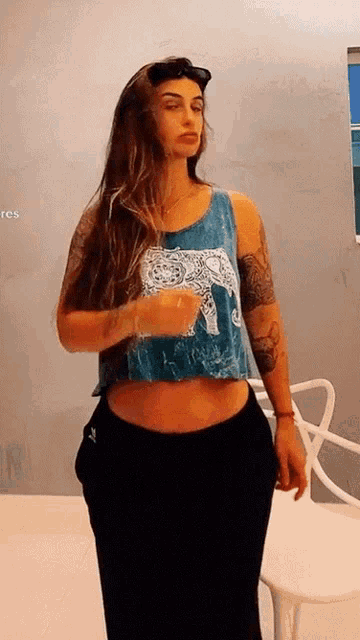 a woman in a blue tank top with an elephant on it